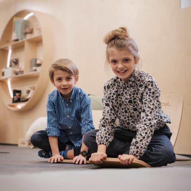 Zwei Kinder spielen in einem modernen Raum.